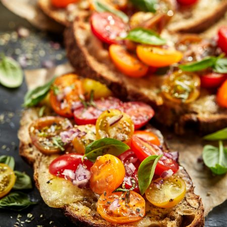 Tomato bruschetta with grilled homemade bread with cheese and fresh herbs Tomato bruschetta with grilled homemade bread with cheese and fresh herbs